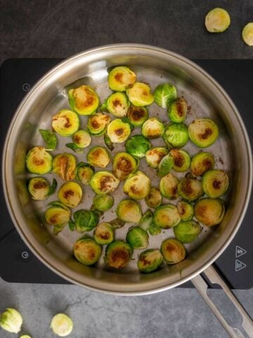 with kitchen tongs turn the sprouts.