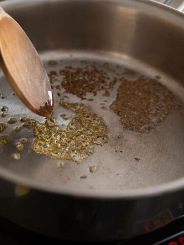 stir frying cumin and fennel seeds.