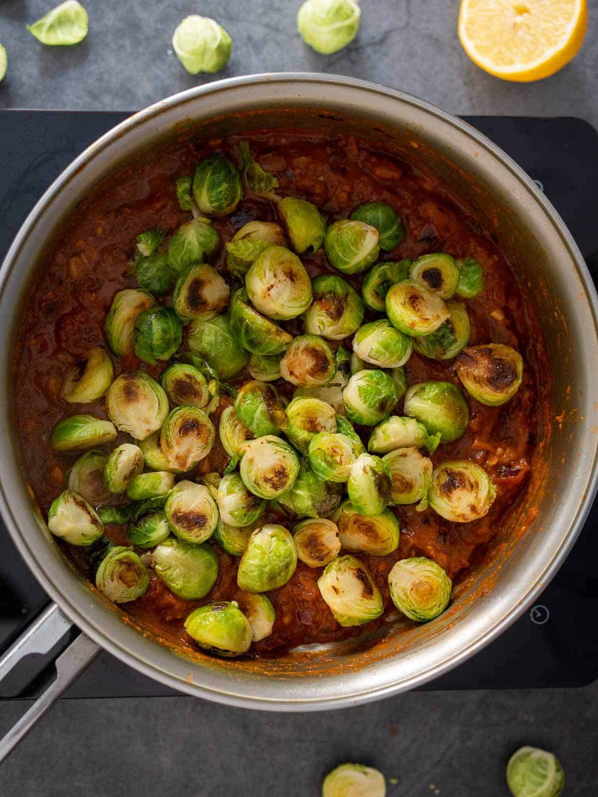 add the seared Brussels sprouts to the tomato sauce mixture.