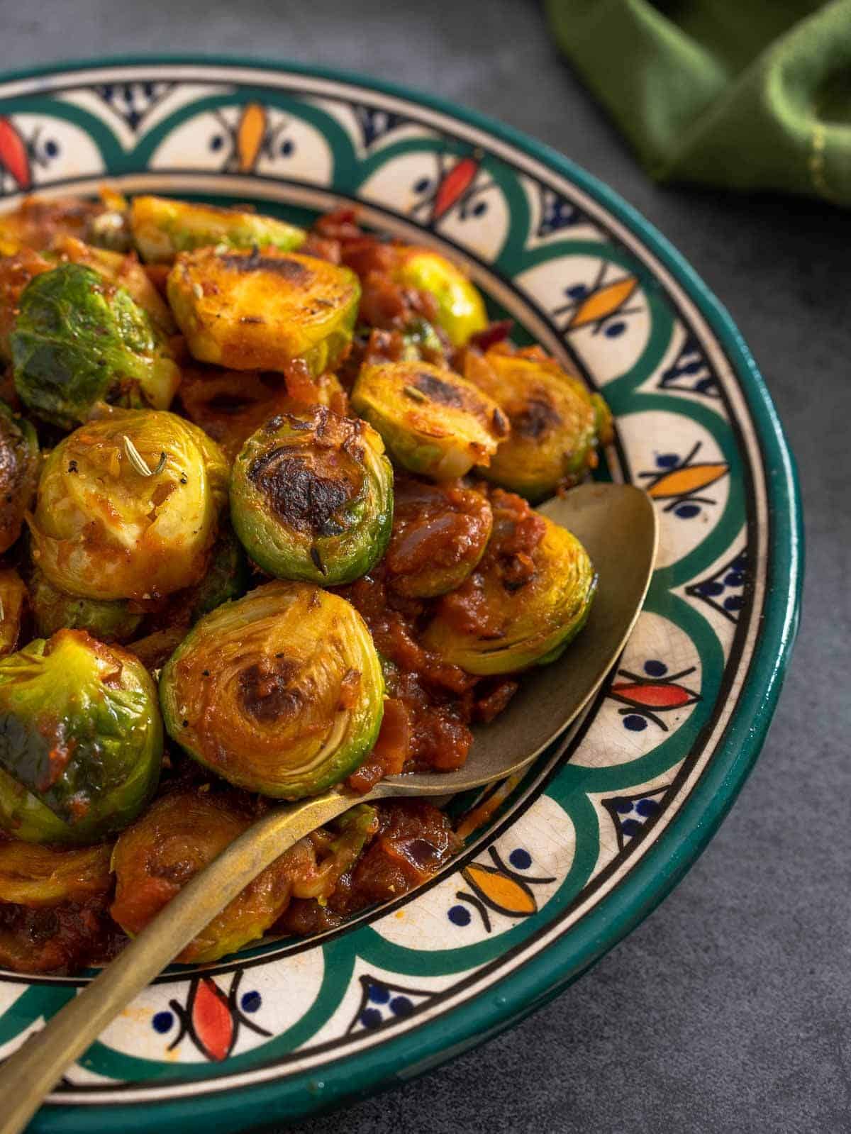 curried Brussels sprouts served in a colorful serving dish.