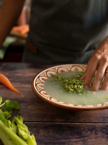 rinsing green peas in a bowl.