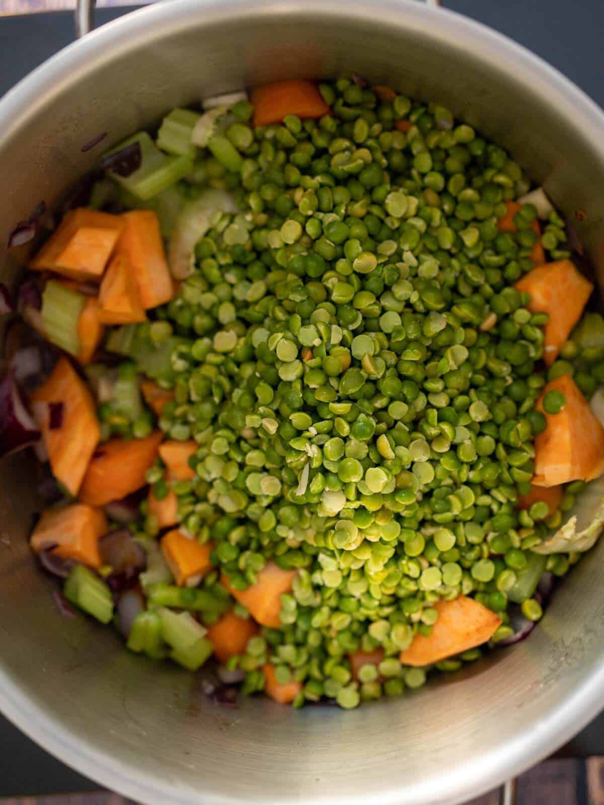 adding drained peas on to the stir-fried-vegetables.