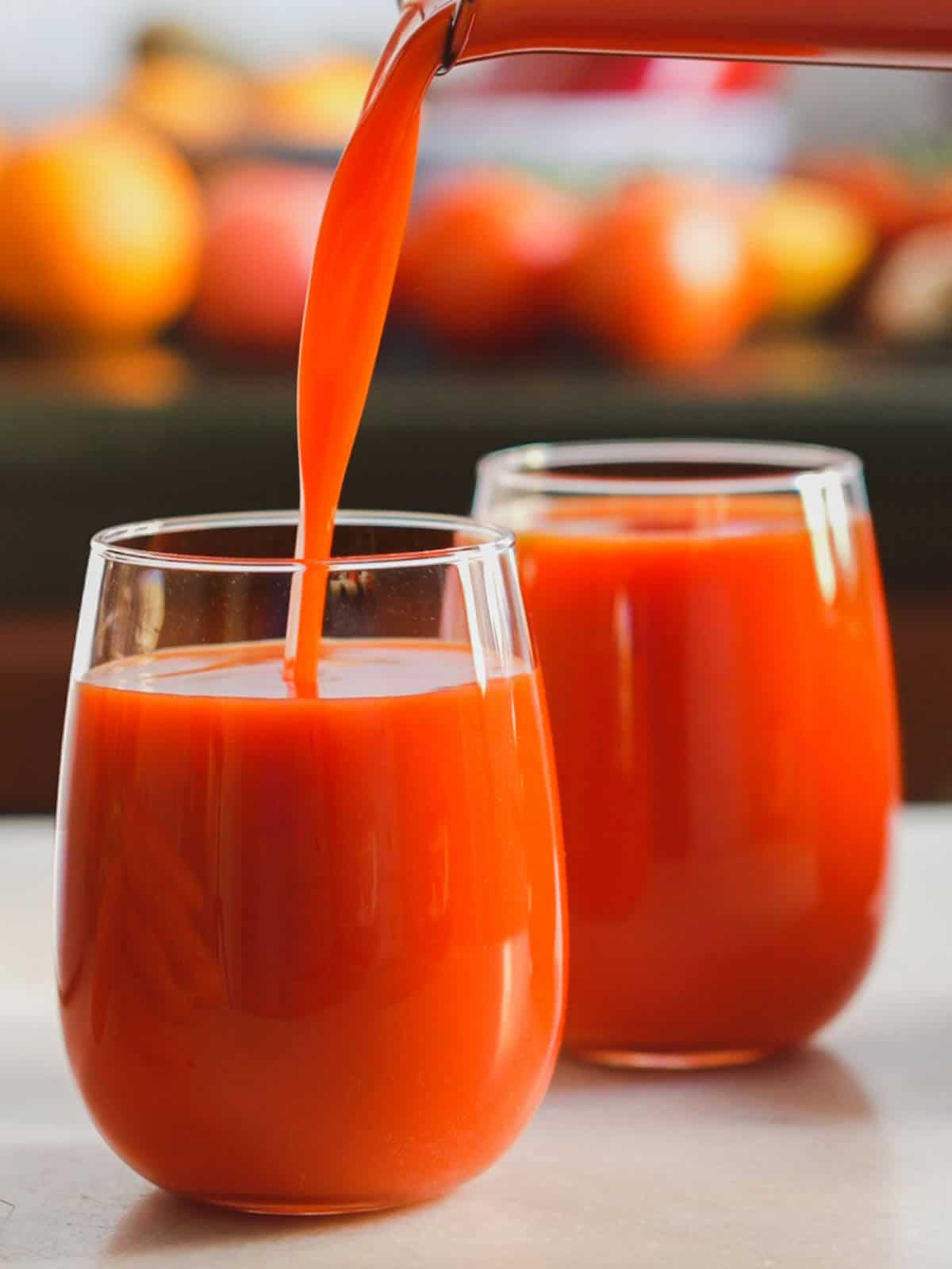 serving freshly made red juice in a glass.