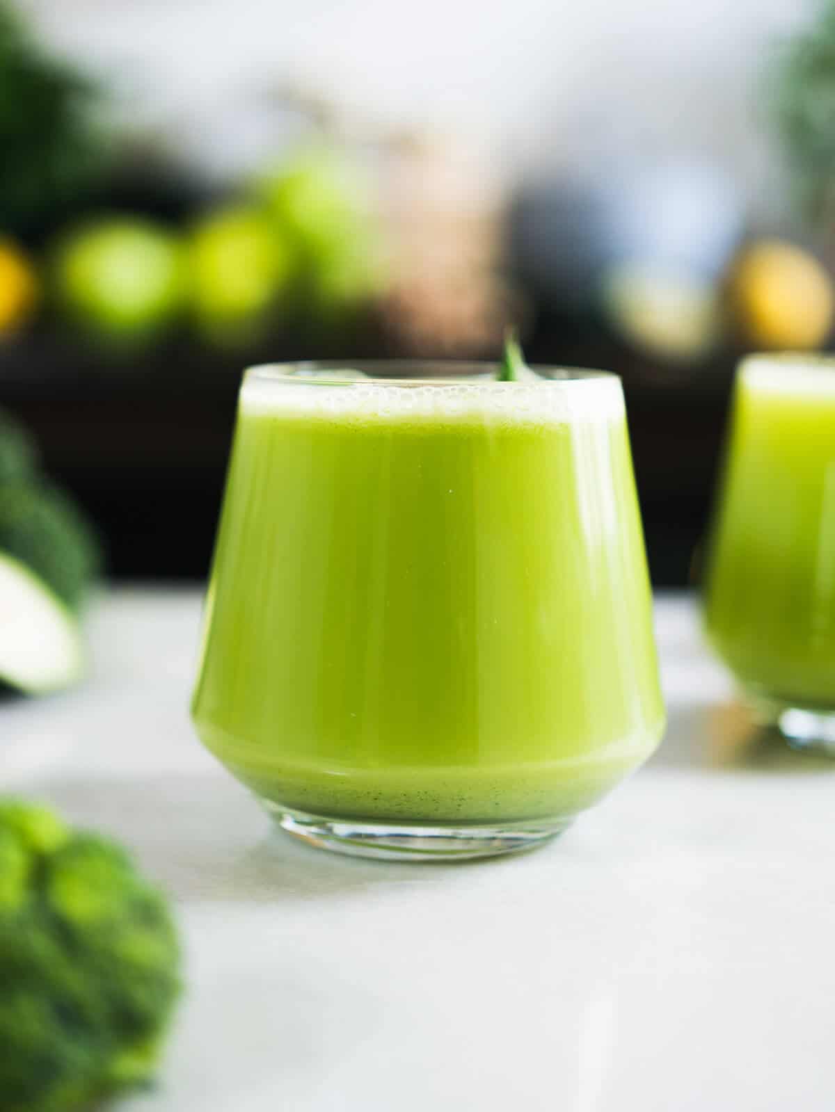 hero image of glass of broccoli green juice served.