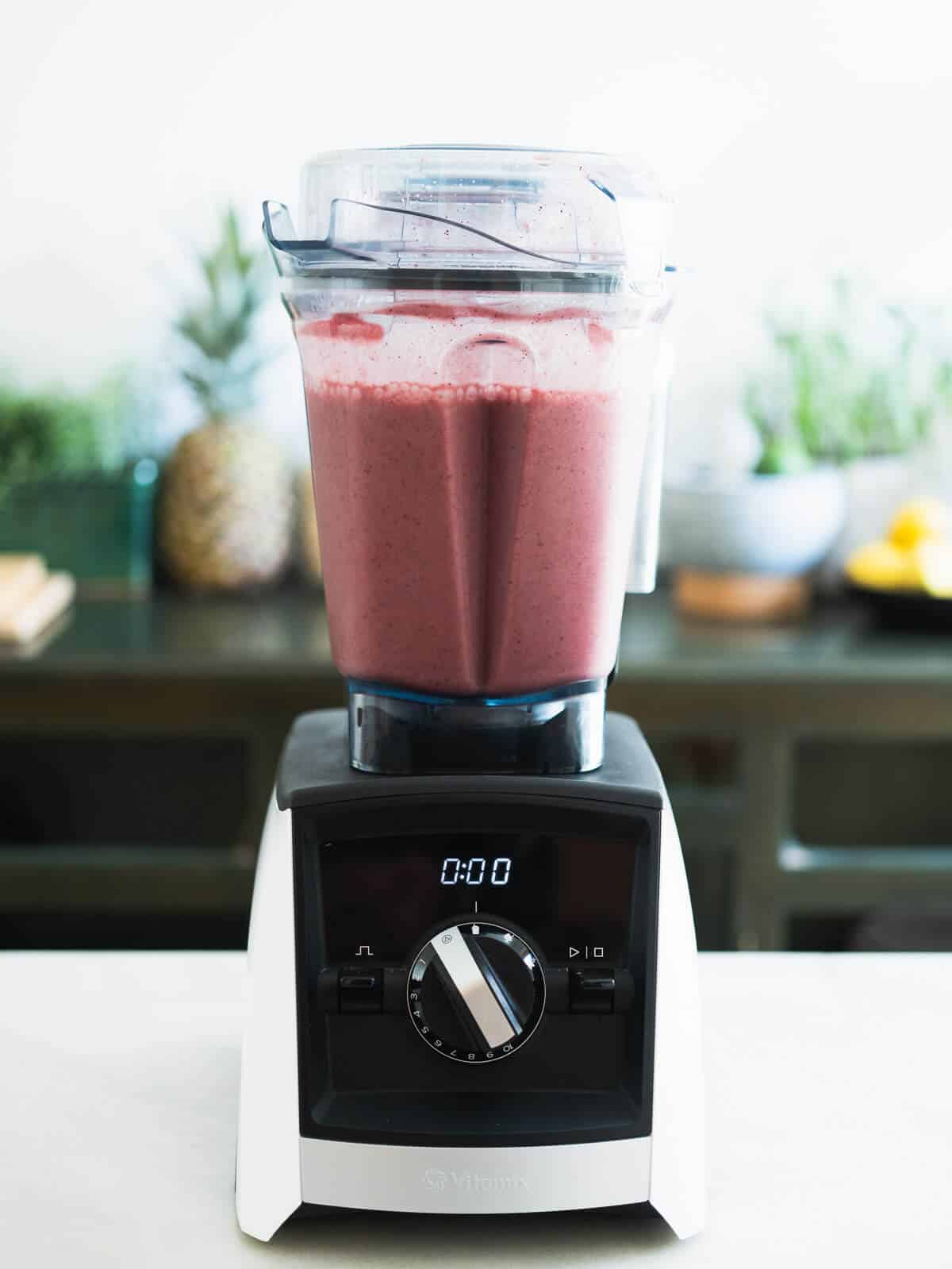 blending blueberry pineapple smoothie.