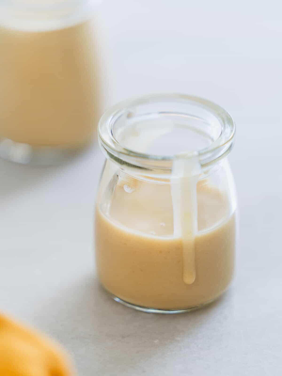tahini dressing for kale salad in a glass recipient.