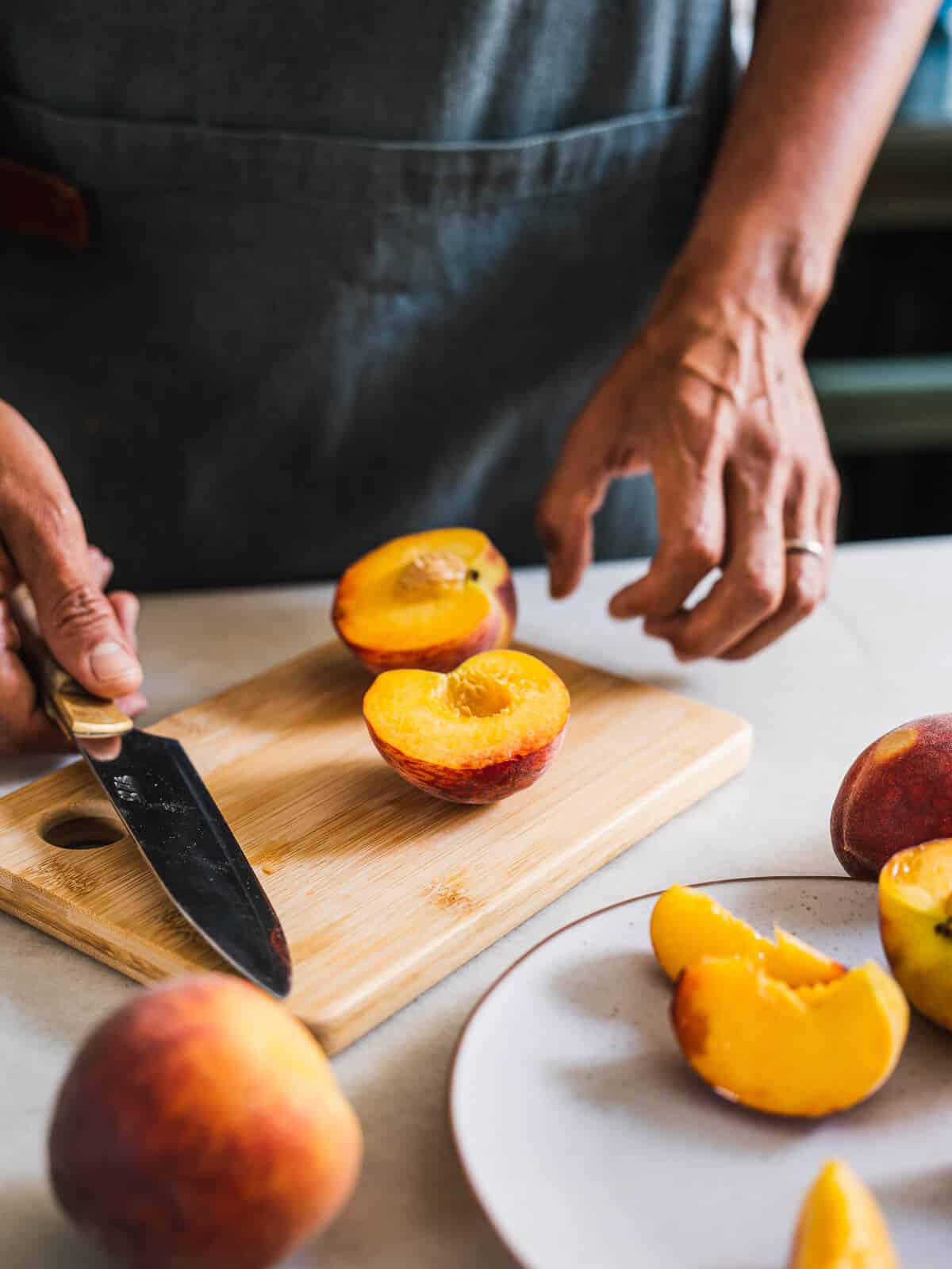 man removing peaches stones.