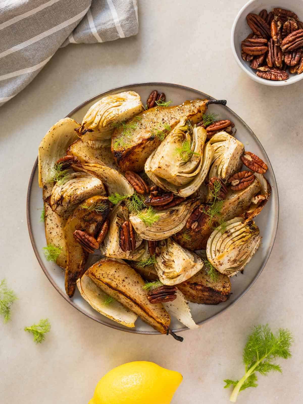 roasted pear and fennel salad served with lemon and extra pecan nuts.