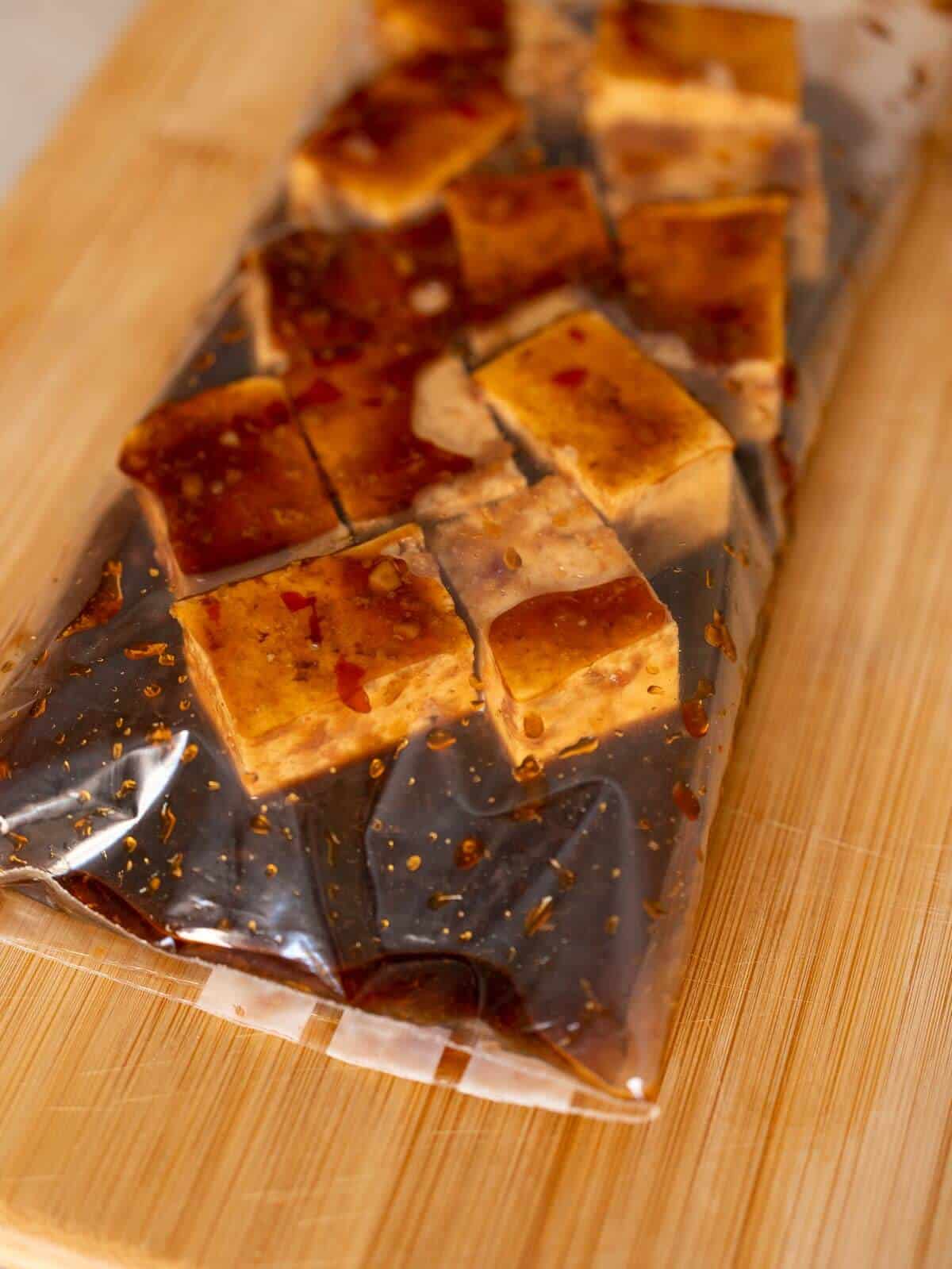 tofu cubes in a ziplock bag with marinade.