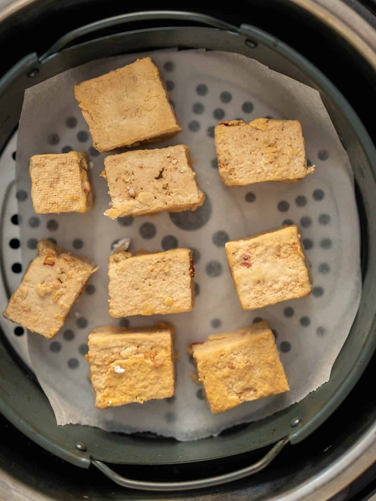 tofu cubes with space between each in air fryer basket.