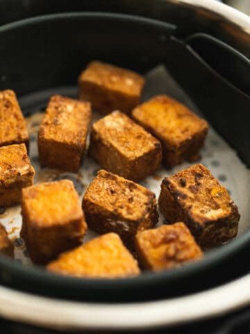 Bake the tofu puffs, shaking the basket or carefully moving the tofu with tongs halfway.