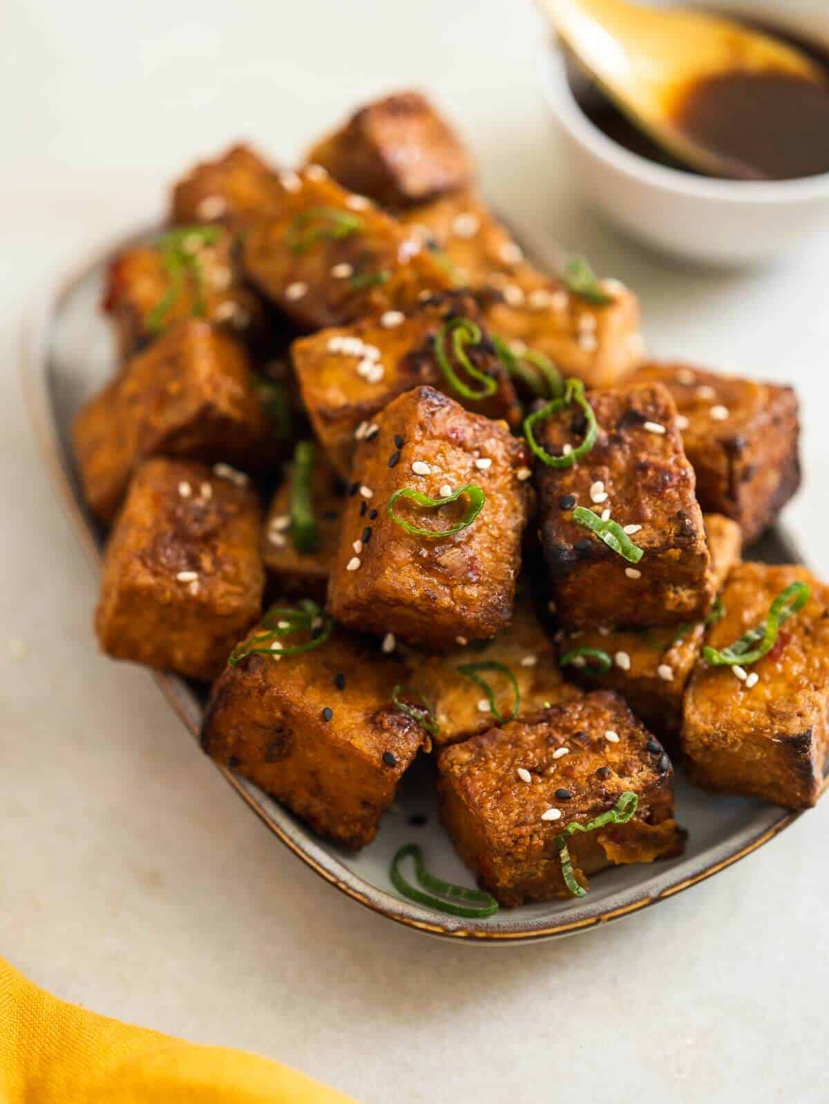 serve the tofu puffs with green onions tops and the remaining marinade.