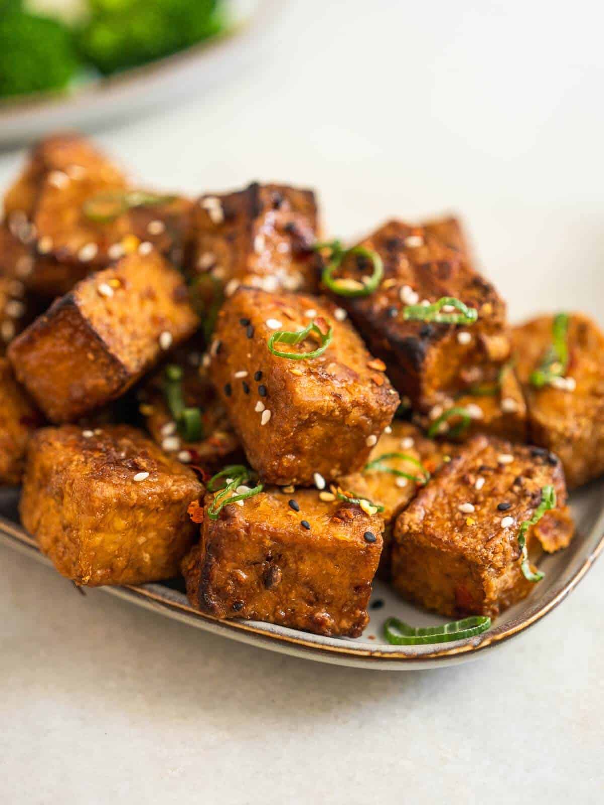 tofu puffs with green onions tops and the remaining marinade.