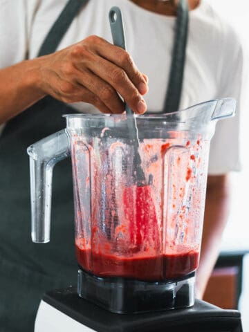 using spatula to scratch blender's sides.