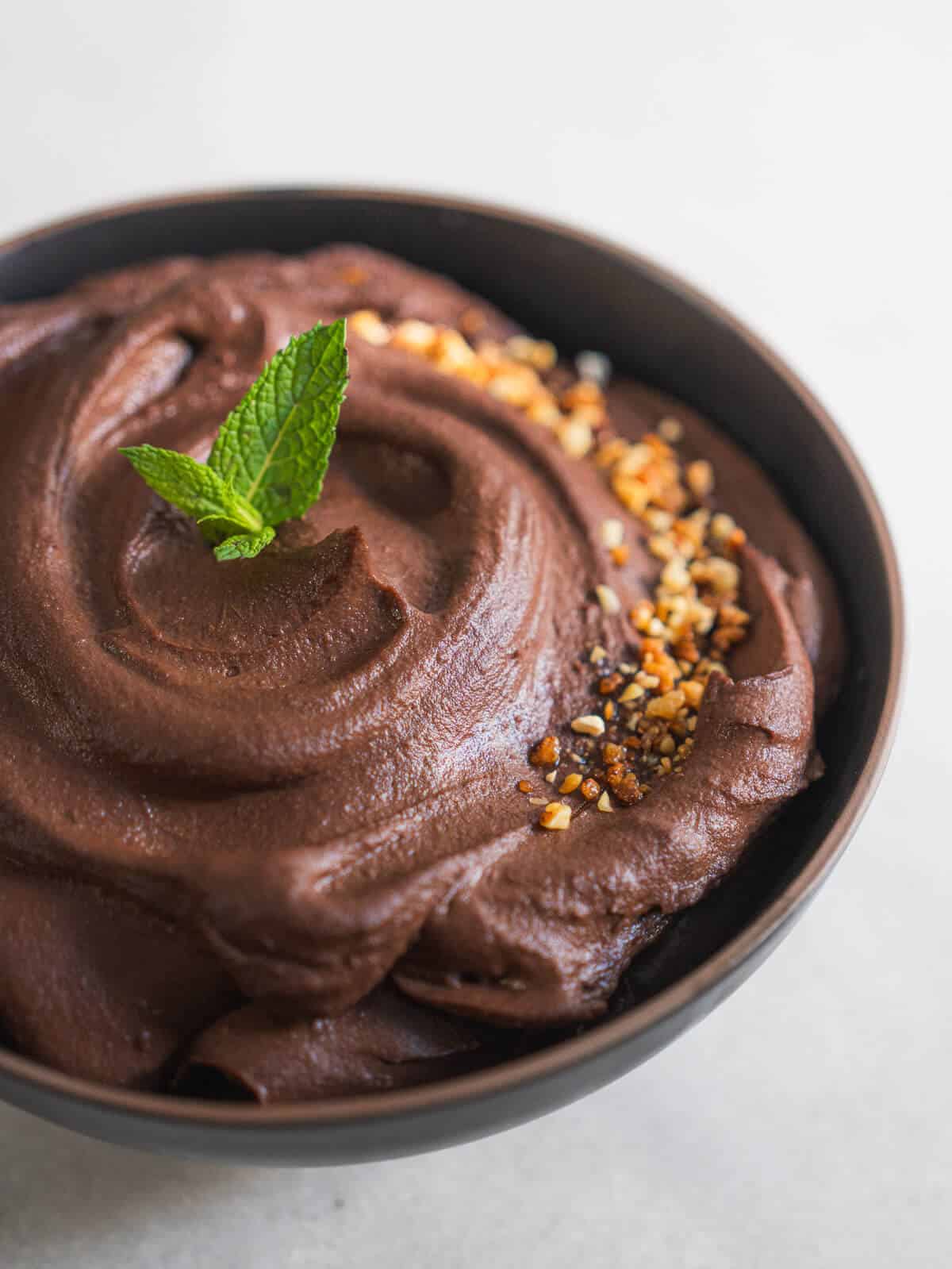 garnish the dark chocolate hummus with crushed almonds and mint leaves.