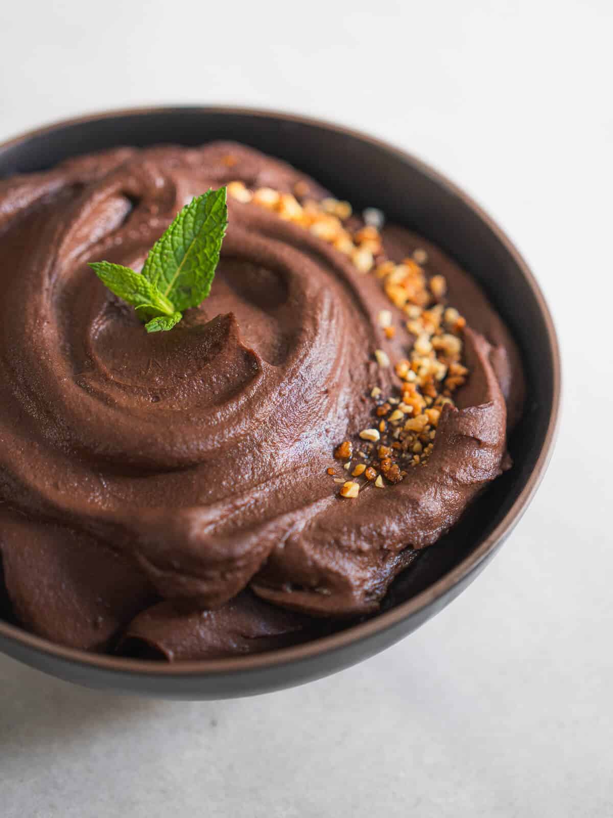 dark chocolate hummus with crushed almonds and mint leaves.
