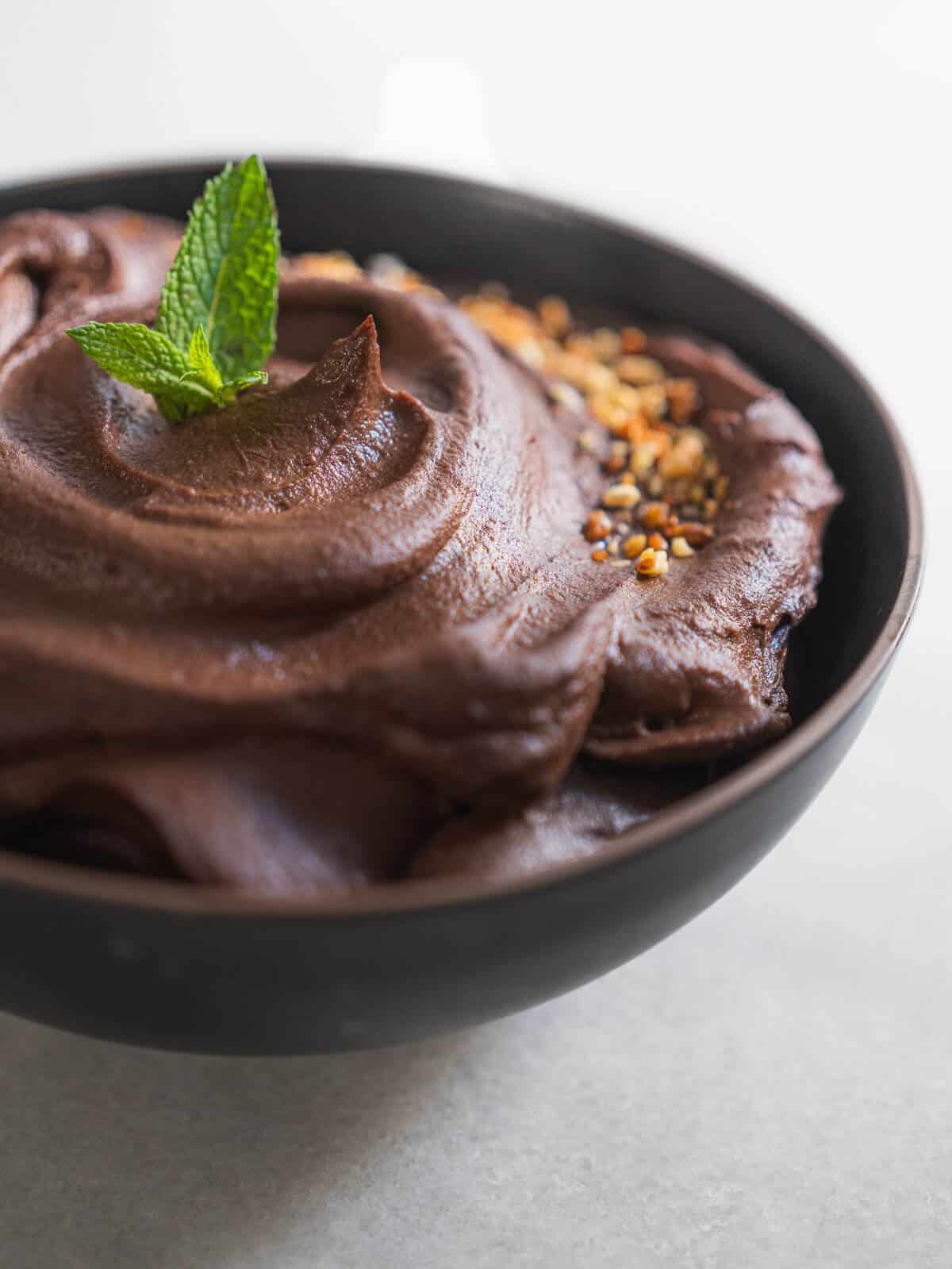 dark chocolate hummus with crushed almonds and mint leaves.