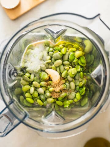 all the ingredients for the edamame hummus in the blender's vase.