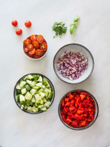 chopped veggies to make mediterranean cucumber chickpea salad.