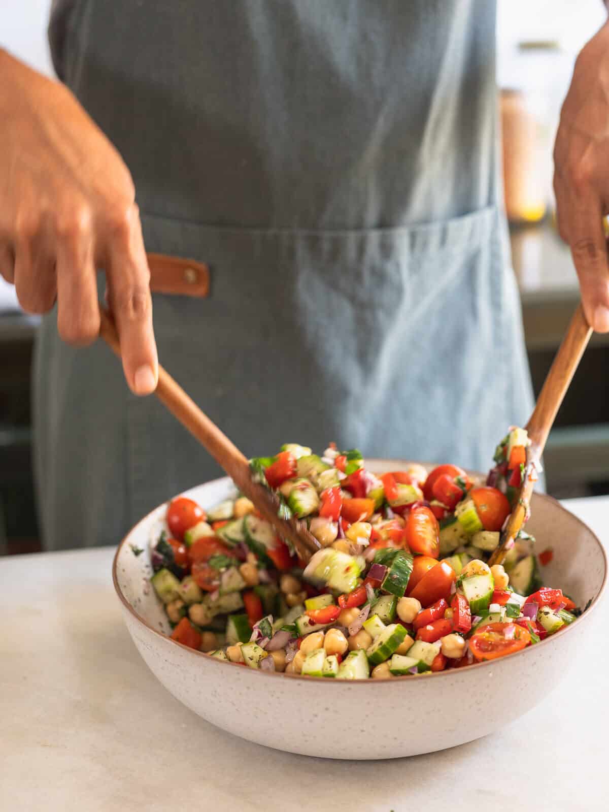 man stirring ingredients of the salad.