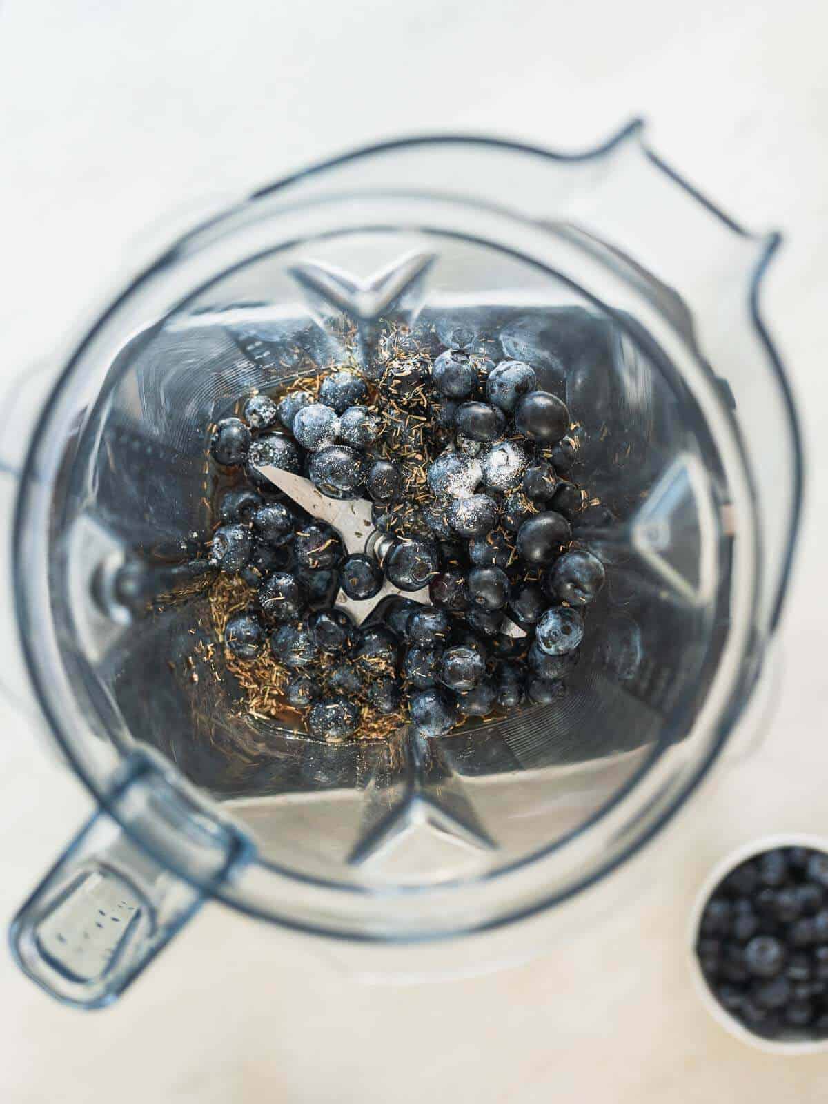 blender's jar with all the unblended blueberry vinaigrette's ingredients.