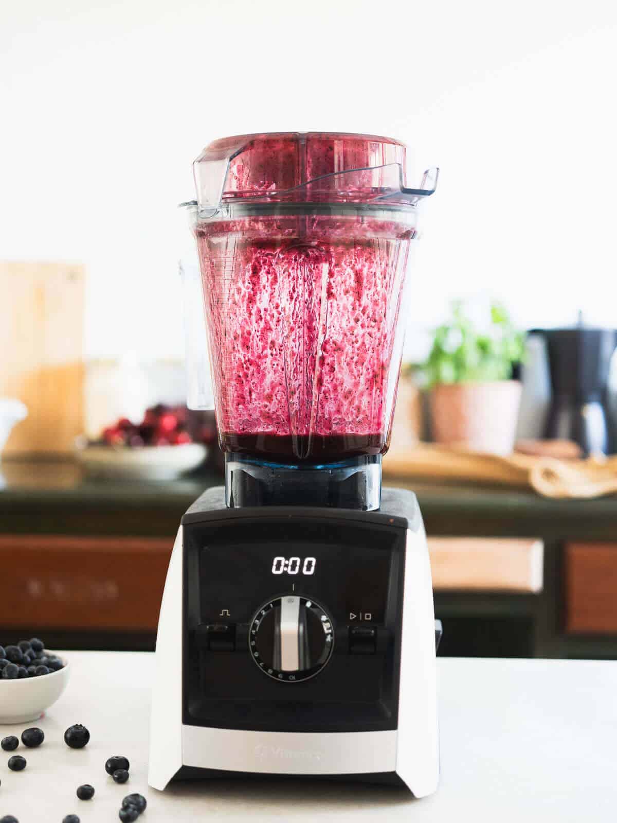 blending blueberry salad dressing in a blender.