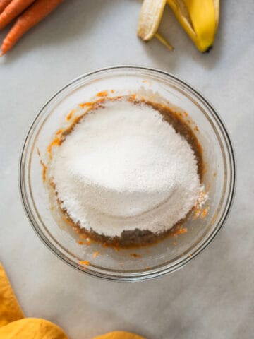 sieved dry ingredients over combined wet ingredients in a large mixing bowl.