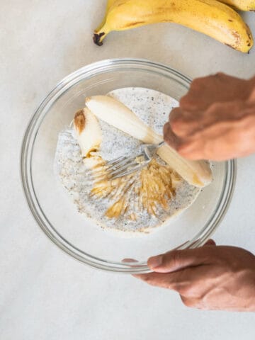 mashing bananas over the chia seeds and vegan buttermilk mix.