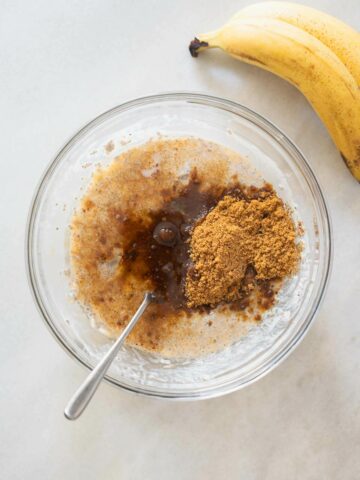 adding brown sugar to wet ingredients and mashed bananas.