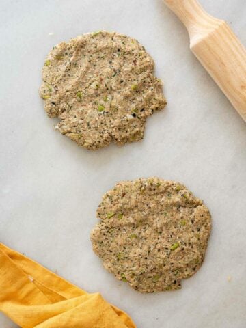 two portions of dough lightly stretched into a patty size.