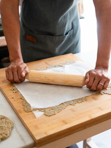 stretching dough with a rolling pin.