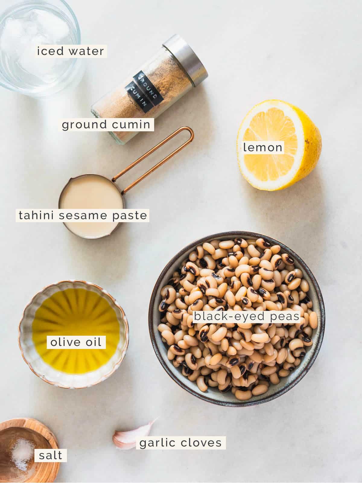 ingredients to make a black eyes peas hummus on a table.