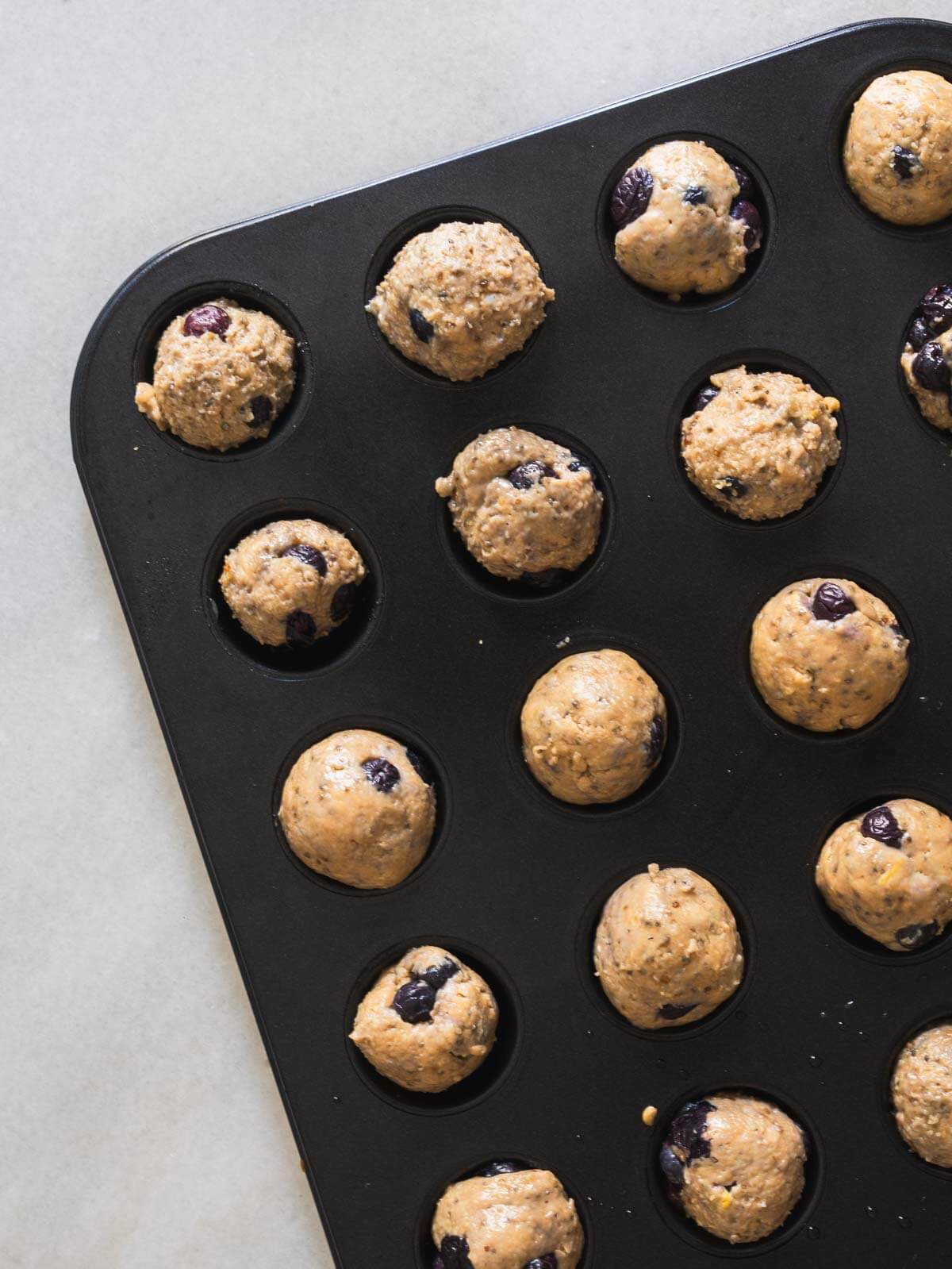 add unbaked muffin balls into the muffin pan.