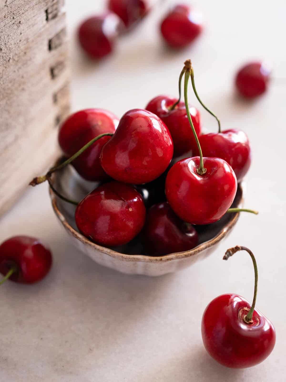 red cherries in a small bowl.