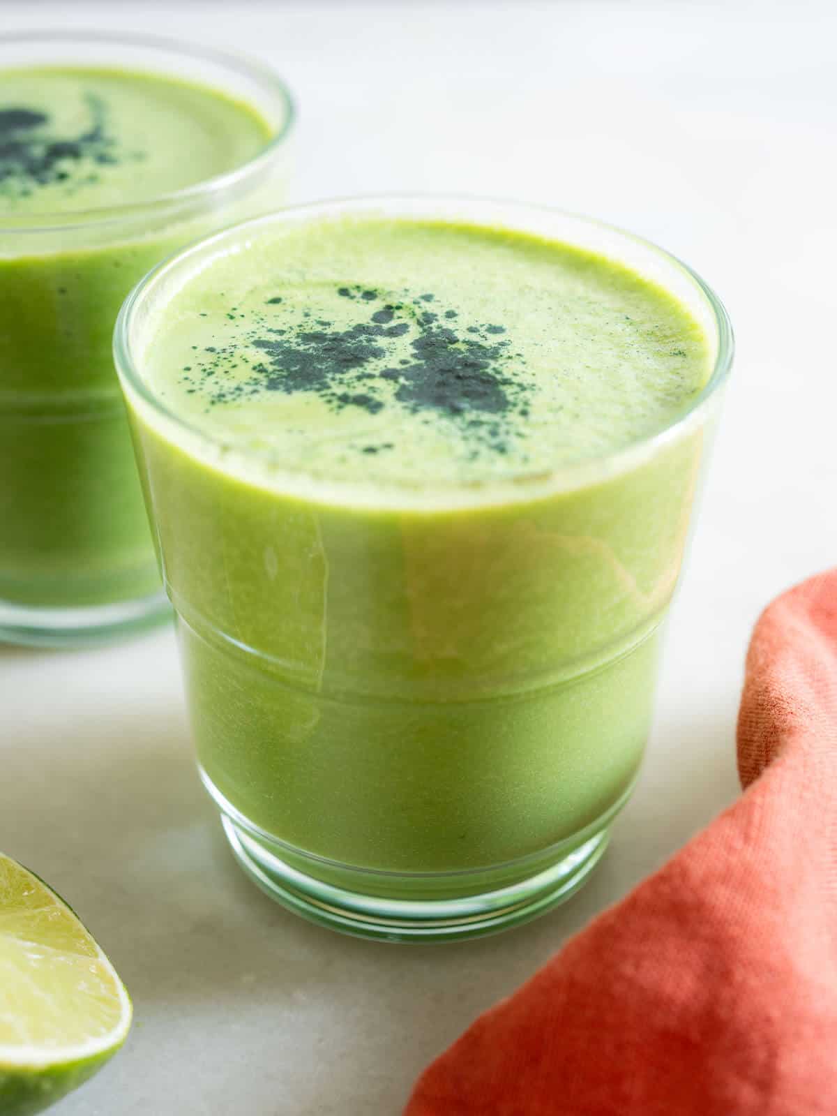 two glasses of green smoothie with avocado.