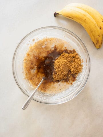 adding brown sugar to wet ingredients and mashed bananas.