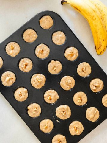 mini banana muffins batter in a mini muffins pan.