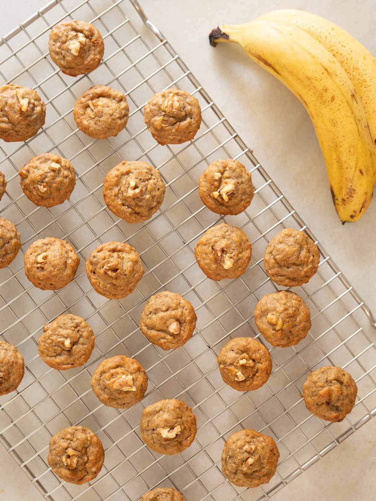 mini banana bread muffins in a cooling rack.