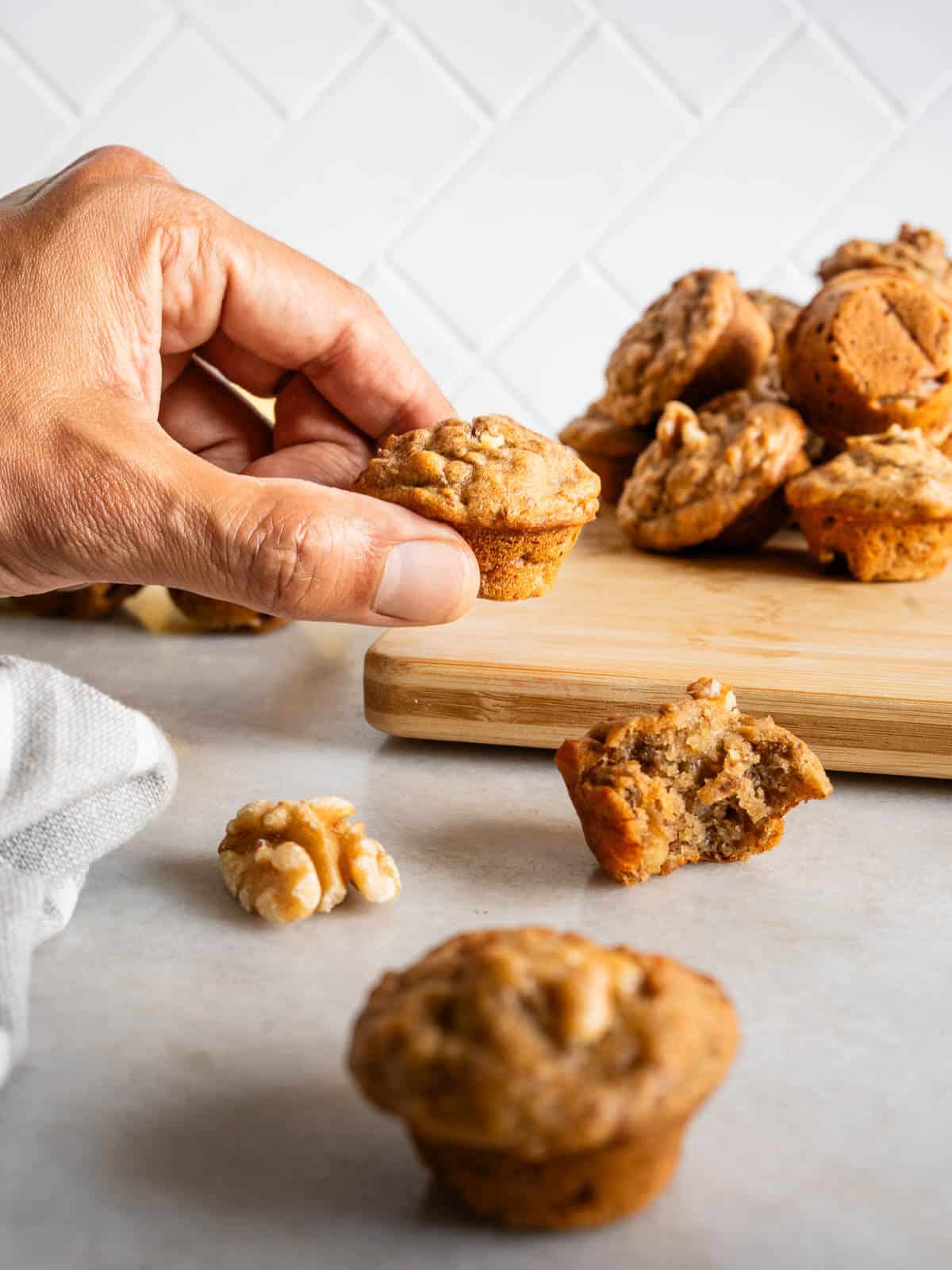 hand holding a mini banana bread muffin.