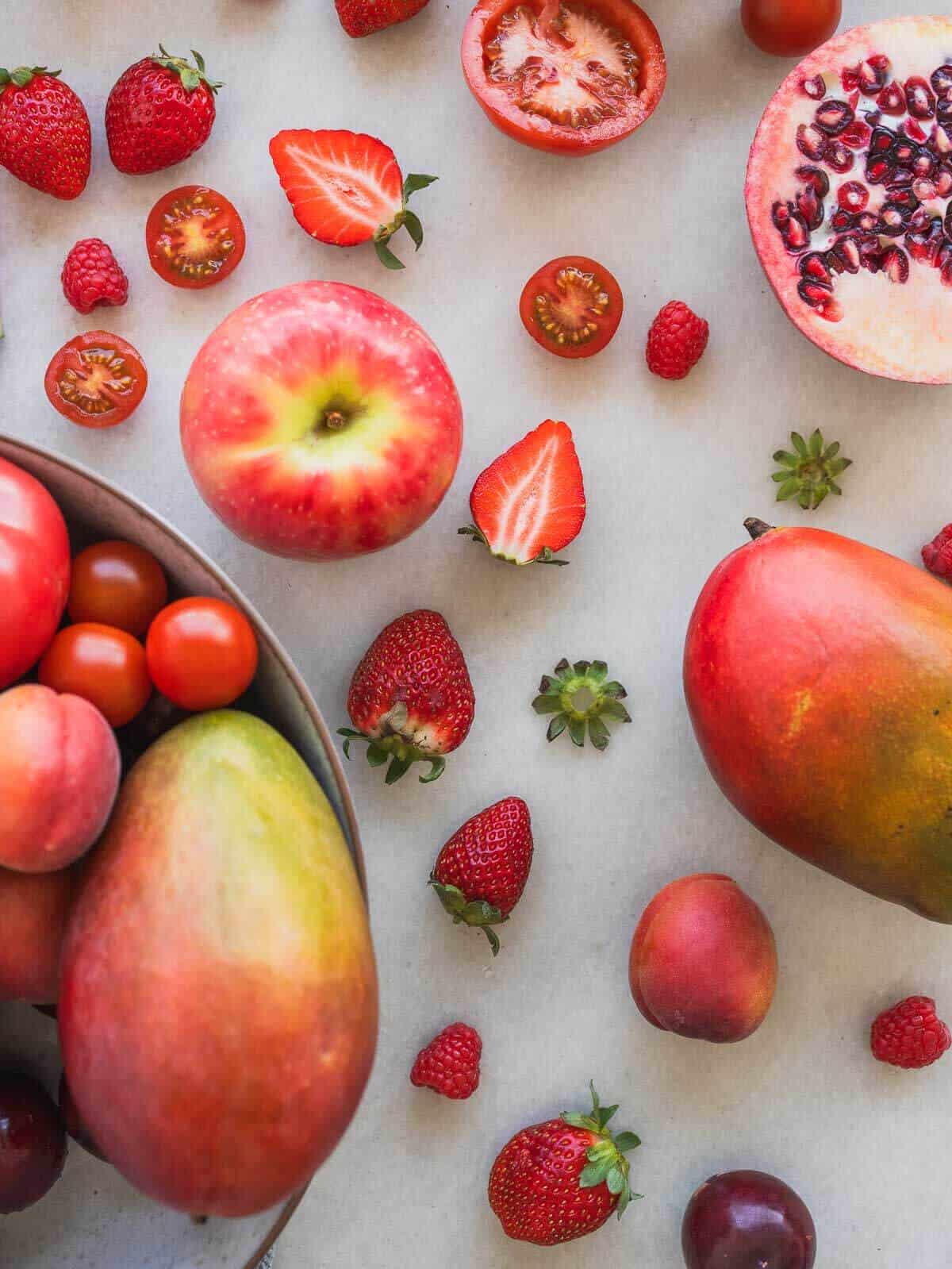 bunch of red fruits in a table.