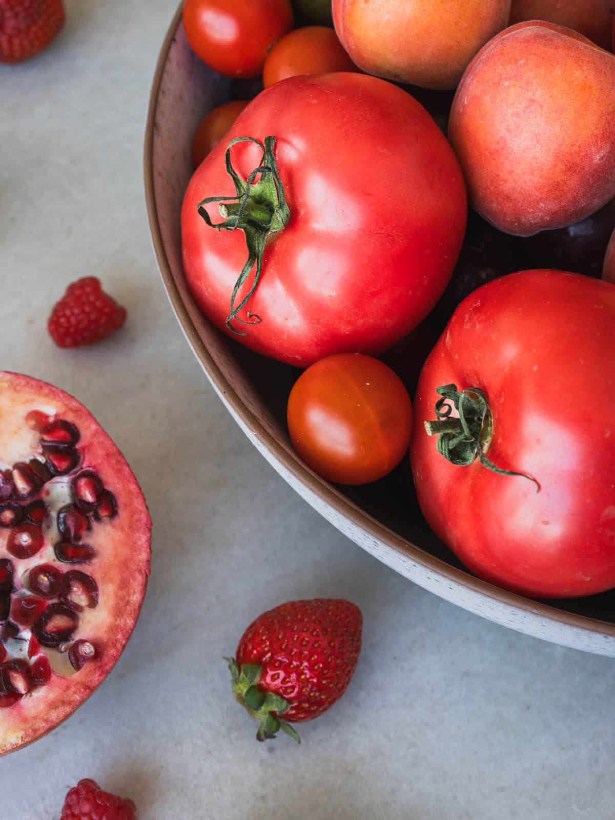 red fruits in a bowl.