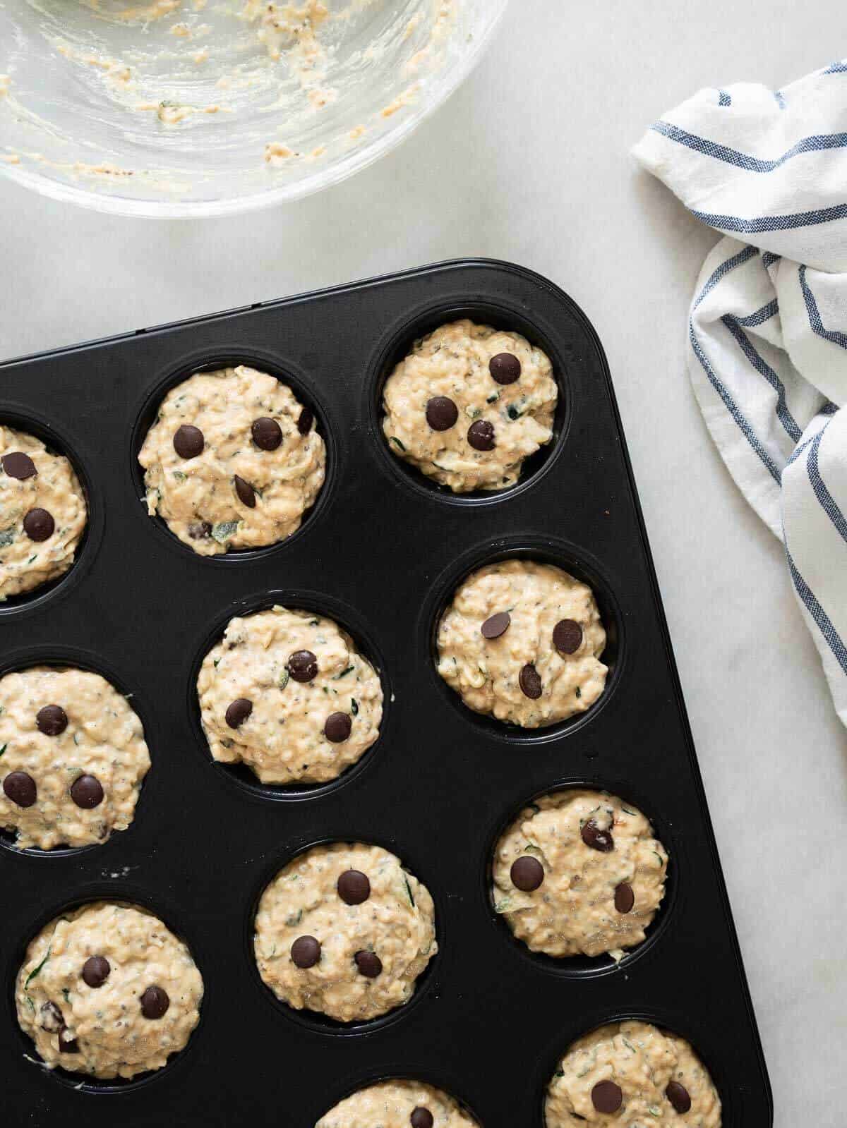add extra chocolate chips on top of the unbaked muffins.