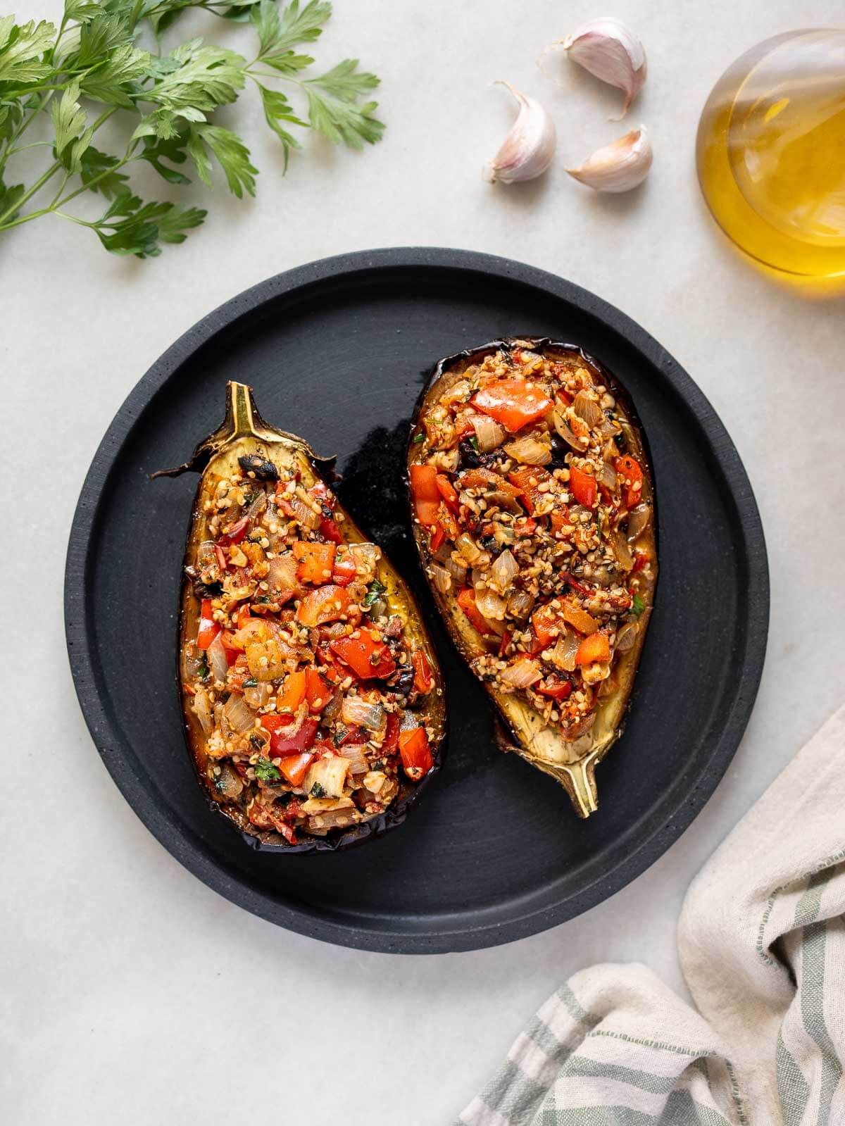 transfer baked stuffed eggplants to a serving plate before garnishing.