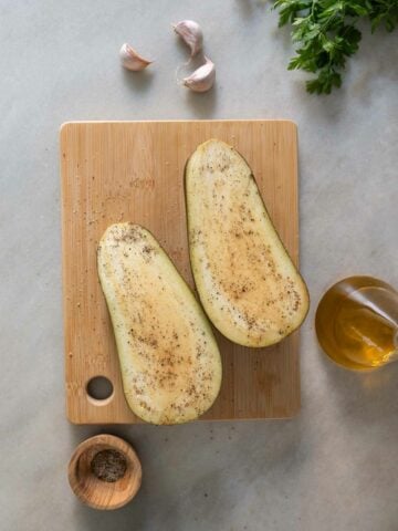 salt and pepper the sliced eggplants.