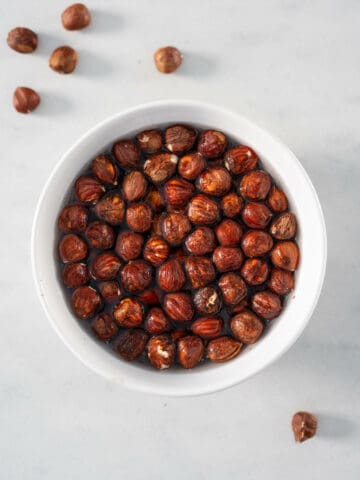 soaking hazelnuts with water in a bowl.