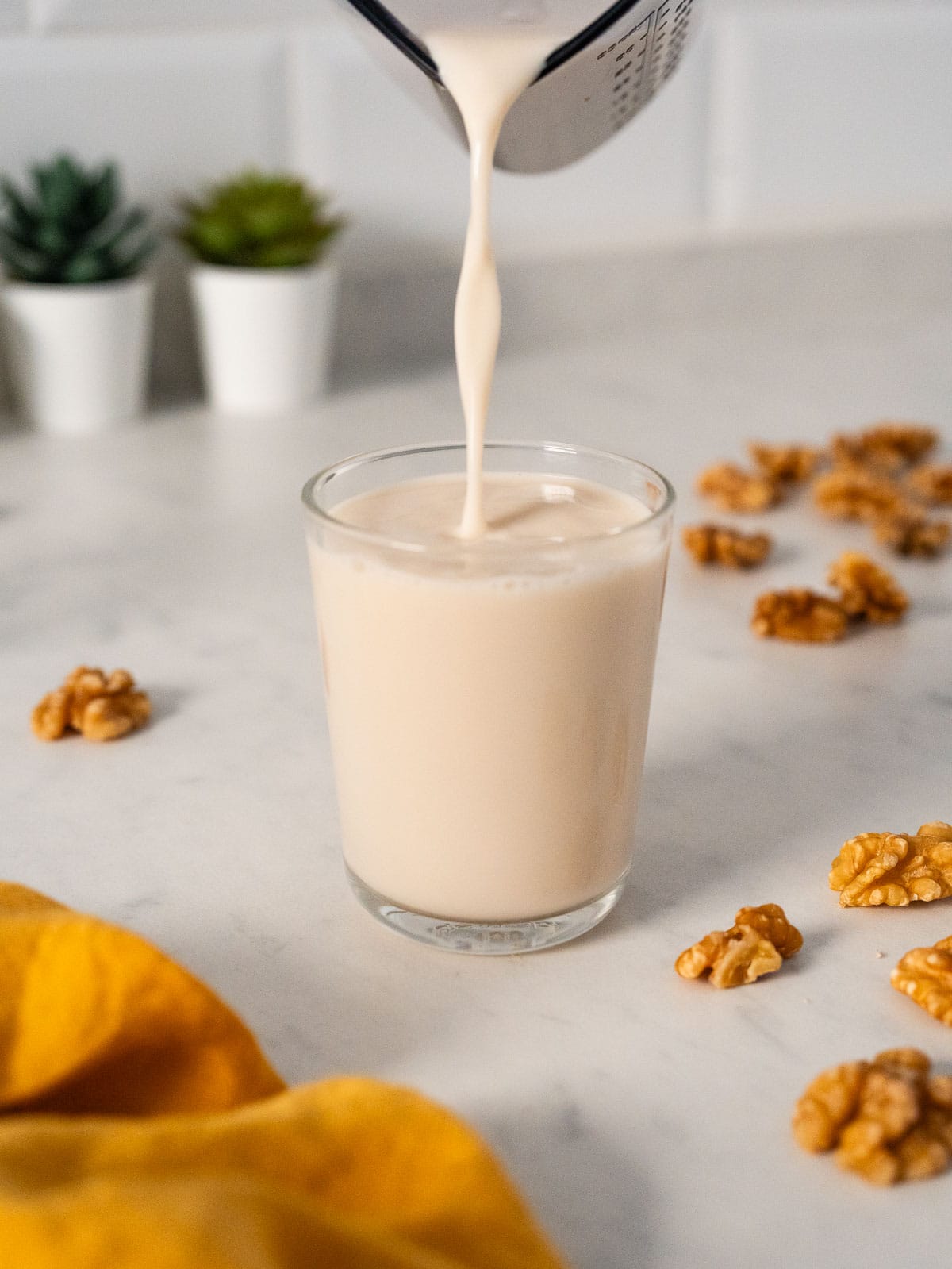 pouring walnut milk.