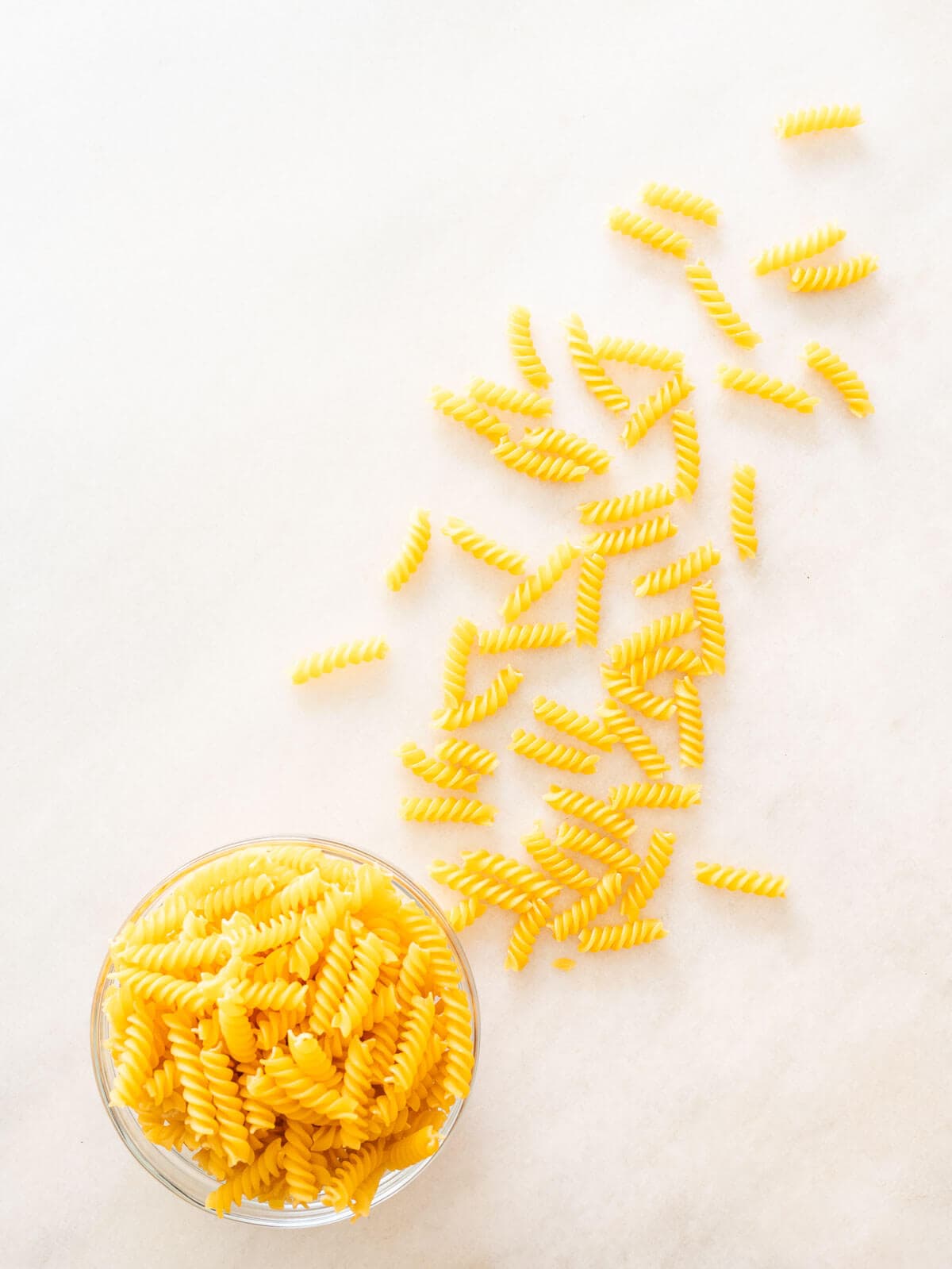 fusilli pasta spread on a table to make this Peas and Pasta Recipe.