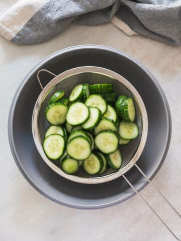 drain the sliced cucumbers with a colander.