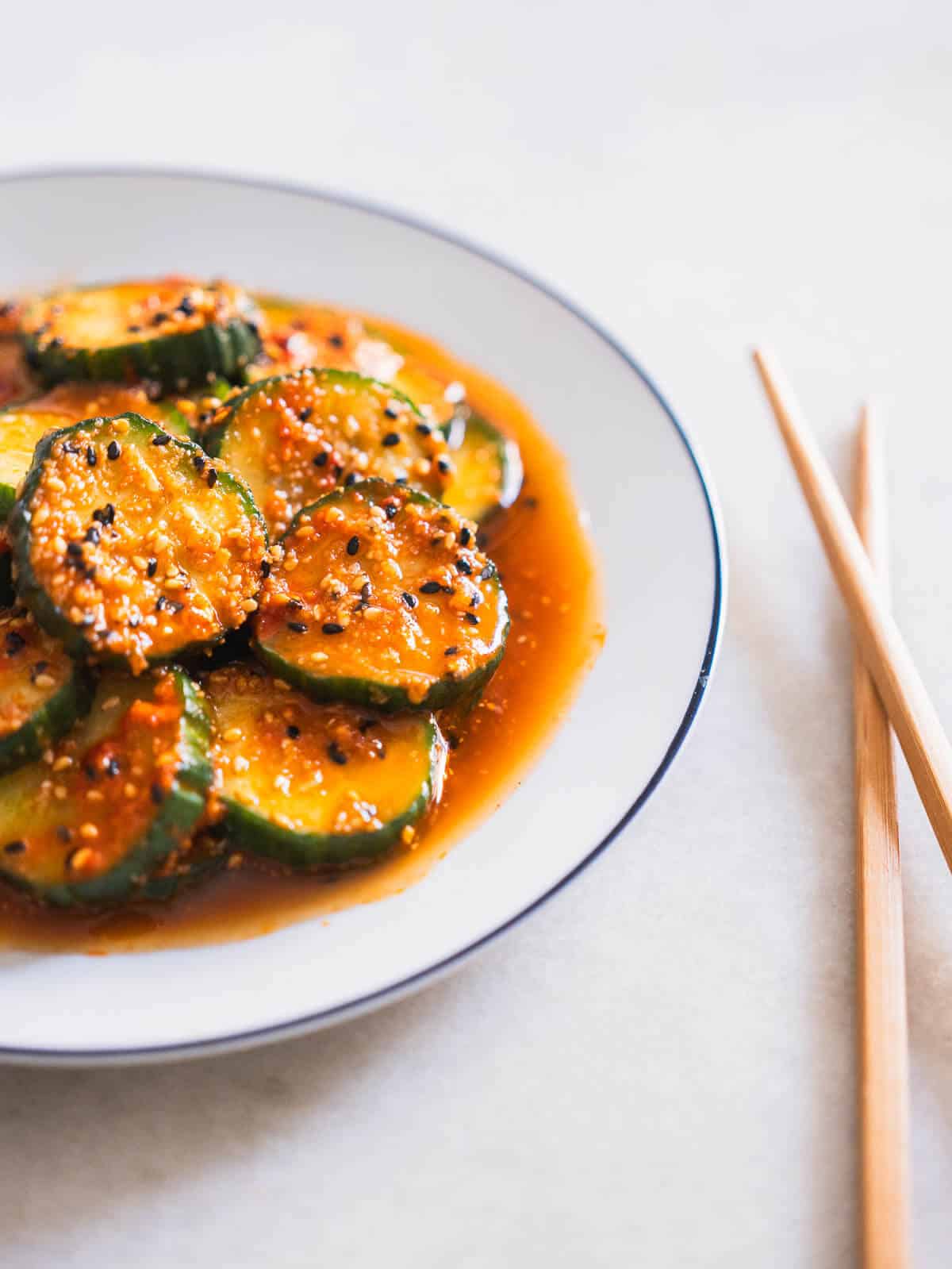 serve the korean cucumber side dish with chopsticks.