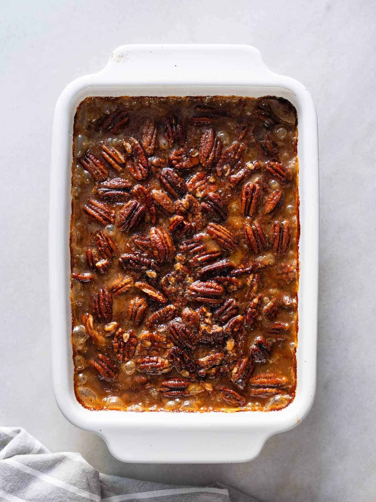 add the pecan mixture on top and take the baking dish back to the oven.